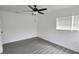 Comfortable bedroom with a ceiling fan, closet, and a large window providing ample natural light at 4105 W Oakellar Ave, Tampa, FL 33611
