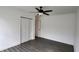 Spacious bedroom with a modern ceiling fan, closet, and light-colored walls and floors at 4105 W Oakellar Ave, Tampa, FL 33611