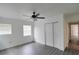 Well-lit bedroom with a ceiling fan, closet, and large windows offering plenty of natural light at 4105 W Oakellar Ave, Tampa, FL 33611
