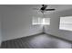 Sunlit bedroom featuring a ceiling fan, and ample natural light from multiple windows at 4105 W Oakellar Ave, Tampa, FL 33611