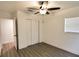 Bright bedroom with a ceiling fan, a closet with sliding doors, and wood-look flooring at 4105 W Oakellar Ave, Tampa, FL 33611