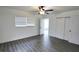 Bedroom featuring new flooring, a ceiling fan, and double sliding closet doors at 4105 W Oakellar Ave, Tampa, FL 33611