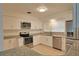 Well-lit kitchen featuring white cabinetry, granite countertops, and stainless steel appliances at 4105 W Oakellar Ave, Tampa, FL 33611