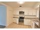 Bright kitchen featuring white cabinetry, granite countertops, and stainless steel appliances at 4105 W Oakellar Ave, Tampa, FL 33611
