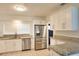 Bright kitchen featuring white cabinetry, granite countertops, and stainless steel appliances at 4105 W Oakellar Ave, Tampa, FL 33611