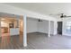 Spacious living room featuring gray flooring, and an open view to the kitchen at 4105 W Oakellar Ave, Tampa, FL 33611