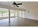 Bright living room with modern gray flooring and a ceiling fan at 4105 W Oakellar Ave, Tampa, FL 33611
