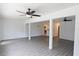 Spacious living room featuring gray flooring, and open columns to other living areas at 4105 W Oakellar Ave, Tampa, FL 33611