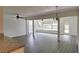 Bright living room with modern gray flooring, a ceiling fan, and a view into the sunroom at 4105 W Oakellar Ave, Tampa, FL 33611