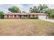 Red brick single-story home with manicured lawn, white trim, and attached garage, offering great curb appeal at 414 Cactus Cir, Seffner, FL 33584