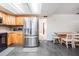 This kitchen features stainless steel appliances, wooden cabinetry, and tile floors, offering functionality and style at 414 Cactus Cir, Seffner, FL 33584