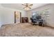 Carpeted living room with natural light, offering a versatile space for relaxation or a home office at 414 Cactus Cir, Seffner, FL 33584