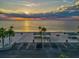 Scenic aerial view of a beach park with picnic areas, parking, and a beautiful sunset over the ocean at 4408 Rudder Way, New Port Richey, FL 34652