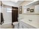 Well-lit bathroom with a shower-tub combo, single sink vanity, and neutral decor at 4408 Rudder Way, New Port Richey, FL 34652