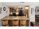 Open kitchen featuring granite countertops, wooden cabinetry, and modern appliances at 4408 Rudder Way, New Port Richey, FL 34652