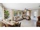 Sunlit living room with tile floors, neutral tones, and stylish wicker furniture at 4408 Rudder Way, New Port Richey, FL 34652