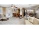 Open-concept living room and kitchen with bar stool seating, neutral walls, and modern appliances at 4408 Rudder Way, New Port Richey, FL 34652