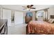Cozy bedroom featuring tile flooring, ceiling fan, TV, and well lit at 4408 Rudder Way, New Port Richey, FL 34652