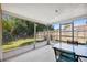 Screened patio overlooking a well-maintained backyard with lush green grass at 4408 Rudder Way, New Port Richey, FL 34652