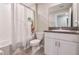 Bright bathroom featuring a tub-shower combo with charming shower curtain and granite top vanity with white cabinets at 4507 Eternal Prince Dr, Sun City Center, FL 33573