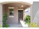 View of the front porch with plants, exterior window and door at 4507 Eternal Prince Dr, Sun City Center, FL 33573