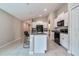 Bright kitchen features granite countertops, an island with bar seating, and stainless steel appliances at 4507 Eternal Prince Dr, Sun City Center, FL 33573