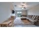 Spacious living room area with a ceiling fan and sliding glass door that leads to the backyard at 4507 Eternal Prince Dr, Sun City Center, FL 33573