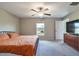 Neutral bedroom features ceiling fan, closet and window allowing for natural light to enter at 4507 Eternal Prince Dr, Sun City Center, FL 33573