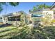 Backyard with patio, table and chairs in a shaded spot near the house at 4509 S Cortez Ave, Tampa, FL 33611