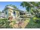 Lawn with chairs, a table set and garden plants at 4509 S Cortez Ave, Tampa, FL 33611