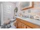 Airy bathroom with seashell decor, framed mirror and floral textured walls at 4509 S Cortez Ave, Tampa, FL 33611