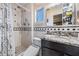 Bathroom features classic tile, updated vanity, and shower with a handheld sprayer at 4509 S Cortez Ave, Tampa, FL 33611