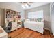 Bright bedroom with wooden floors, ceiling fan, bookshelf and white metal frame bed at 4509 S Cortez Ave, Tampa, FL 33611