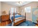 Bedroom featuring wood floors, ceiling fan, and ample natural light at 4509 S Cortez Ave, Tampa, FL 33611