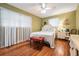 Charming bedroom featuring wood floors, lots of natural light, a ceiling fan, and a neutral color scheme at 4509 S Cortez Ave, Tampa, FL 33611
