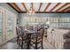 Eat-in dining room with wood beams, large window, wood dining table, and adjacent living area at 4509 S Cortez Ave, Tampa, FL 33611