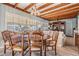 Dining area with wood beams, large window, seating for eight, and view of the adjacent living room at 4509 S Cortez Ave, Tampa, FL 33611