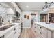 Stylish kitchen with white cabinets, stainless steel appliances, and a view into the dining area at 4509 S Cortez Ave, Tampa, FL 33611