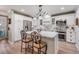Modern kitchen featuring white cabinets, stainless steel appliances, and a stylish center island with seating at 4509 S Cortez Ave, Tampa, FL 33611