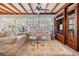 Bright and airy living room with wood beams, natural light, comfortable seating, and built-in shelving at 4509 S Cortez Ave, Tampa, FL 33611