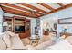 Cozy living room with wood beamed ceiling, wood built-ins, light blue walls and lots of natural light at 4509 S Cortez Ave, Tampa, FL 33611
