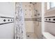 Shower with a handheld sprayer and a black and white tile border at 4509 S Cortez Ave, Tampa, FL 33611
