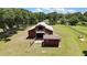 Aerial view of barn and the property, highlighting its serene and private setting next to the water at 4706 Scott Rd, Lutz, FL 33558