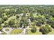 Sprawling home with mature trees, a long driveway, a serene lake, and additional outbuildings nestled on a lush, expansive lot at 4706 Scott Rd, Lutz, FL 33558