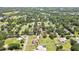 Aerial view of property highlighting the home's location, pond, and surrounding trees at 4706 Scott Rd, Lutz, FL 33558