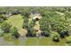 Expansive land featuring lush greenery, a tranquil pond, and a well-maintained barn with a red roof at 4706 Scott Rd, Lutz, FL 33558