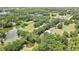 The property's verdant foliage, ponds, barn, and abundant tree cover are captured from above at 4706 Scott Rd, Lutz, FL 33558