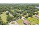 An aerial shot shows the house, set among mature trees, surrounded by a lush landscape at 4706 Scott Rd, Lutz, FL 33558
