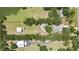 Expansive property with a serene pond, spacious main house with pool, and versatile outbuildings offering ample space at 4706 Scott Rd, Lutz, FL 33558