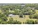 A high angle shot shows the property's pond, barn, and lush surroundings at 4706 Scott Rd, Lutz, FL 33558